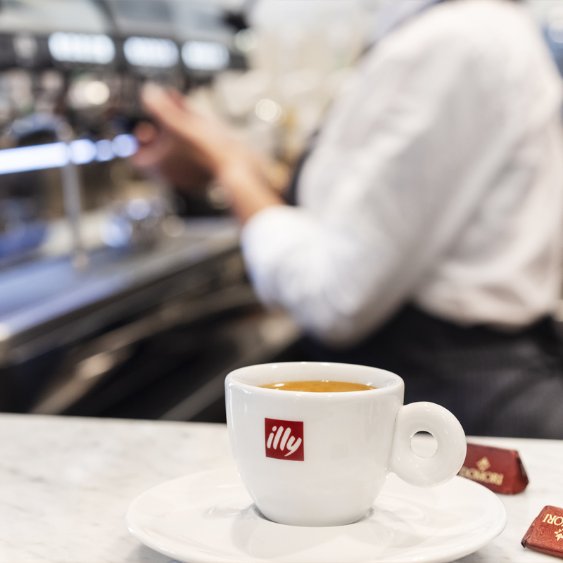 coffee cup with with Illy logo filled with espresso