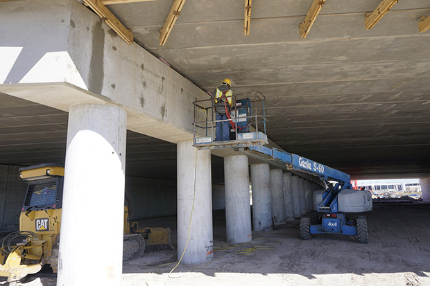 Placing concrete beams for new Taxiway J bridge