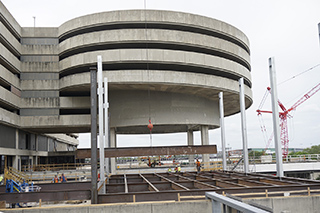 Steel beam hoisted into place for the Main Terminal modernization project