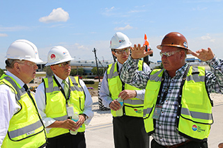 Larry Self explains Taxiway J to Watkins and Execs