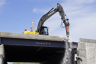 Hydraulic breaker in action demolishing Taxiway J