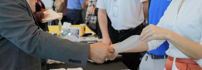 hands exchanging a resume