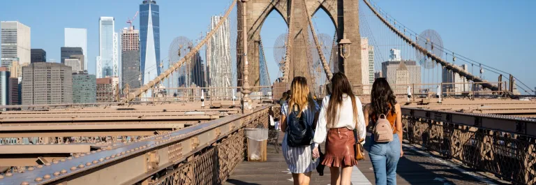 women walking on nyc bridge in summer