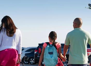 Family walking in parking lot