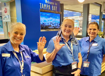three female TPA ambassadors waving hello