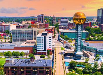 Aerial view of the city of Knoxville, including the Sunsphere, a 75 foot tall gold colored glass sphere.