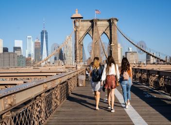 women walking on nyc bridge in summer