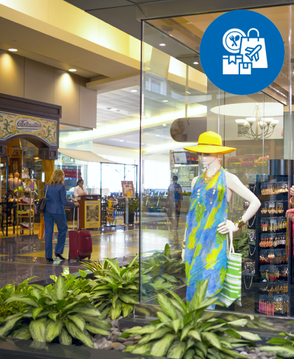 store window at TPA with passenger with rolling luggage in backgound