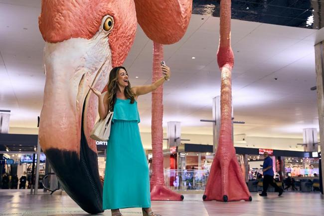 Passenger taking selfie with artwork