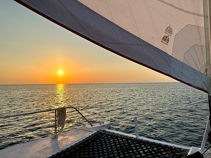 view of sunset near Grand Cayman off the deck of a sailboat
